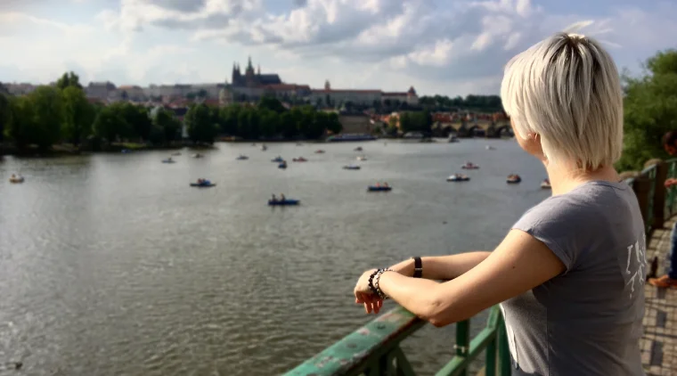 Nika Mak from a side watching Prague castle with river view and warm weather
