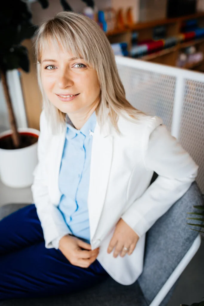 Nika Mak performance mindset coach white jacket with light blue shirt in the light room